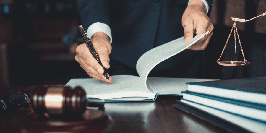 judge-looking-at-law-book-with-gavel-on-desk